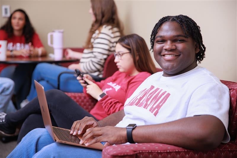 Transfer student sitting with laptop