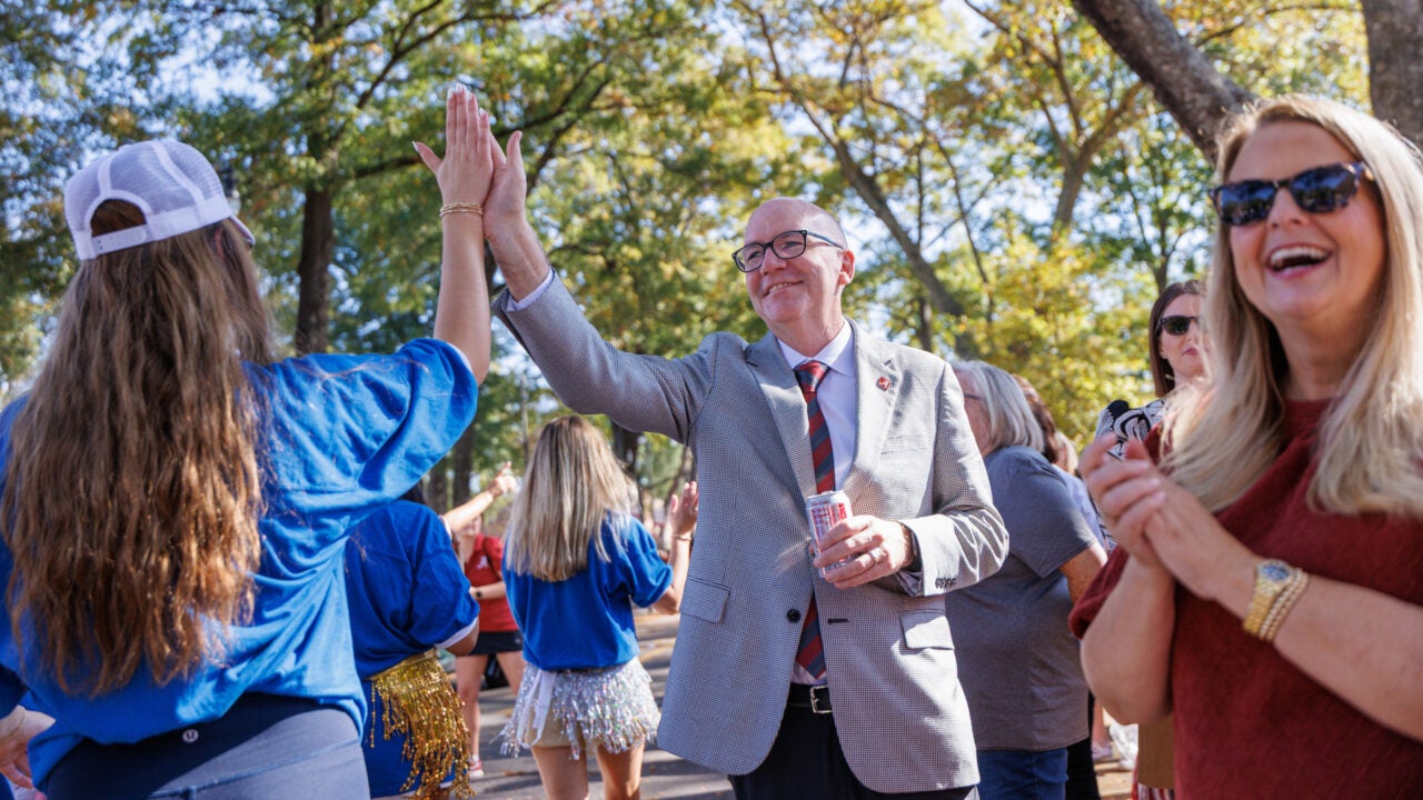 Dr. Mohler high fives a student