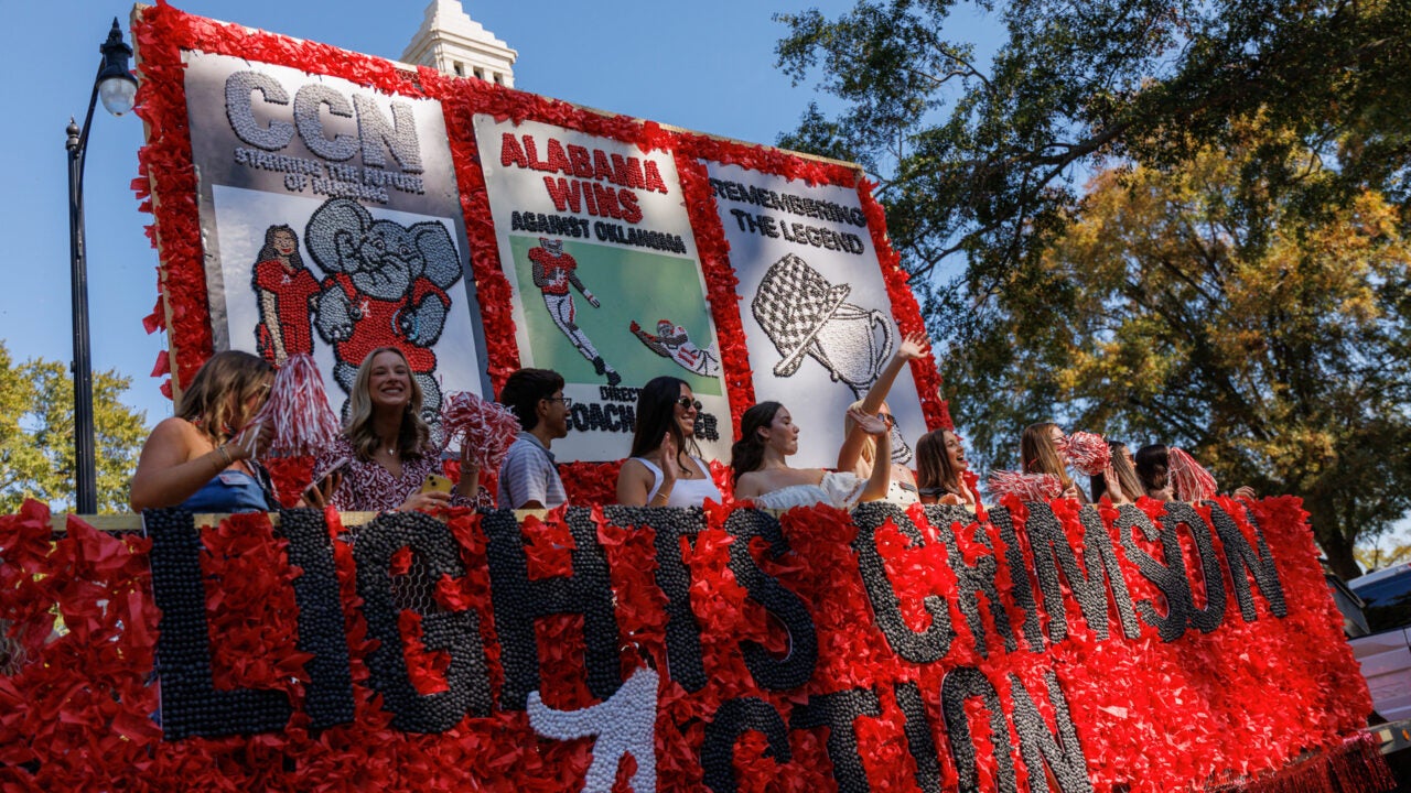 a parade float with the 2025 homecoming theme, "lights, crimson, action," written on the side