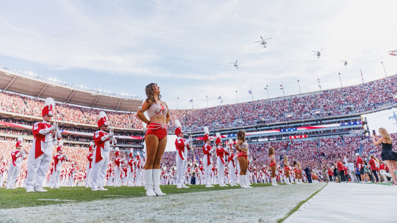helicopters fly over the stadium during the 2025 homecoming game
