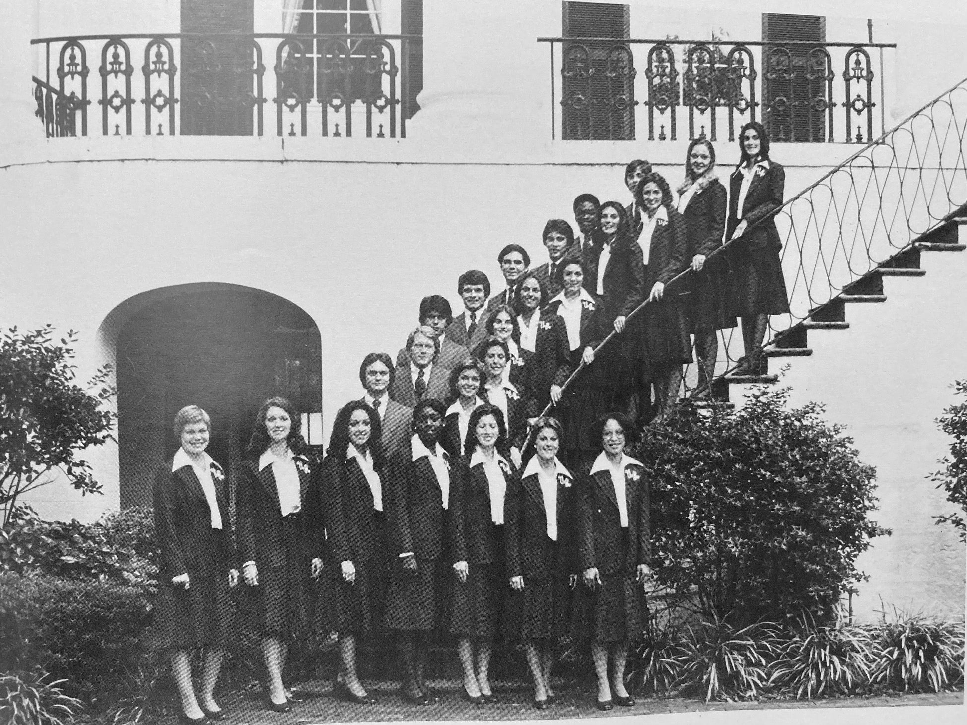 A row of students stands on a staircase.