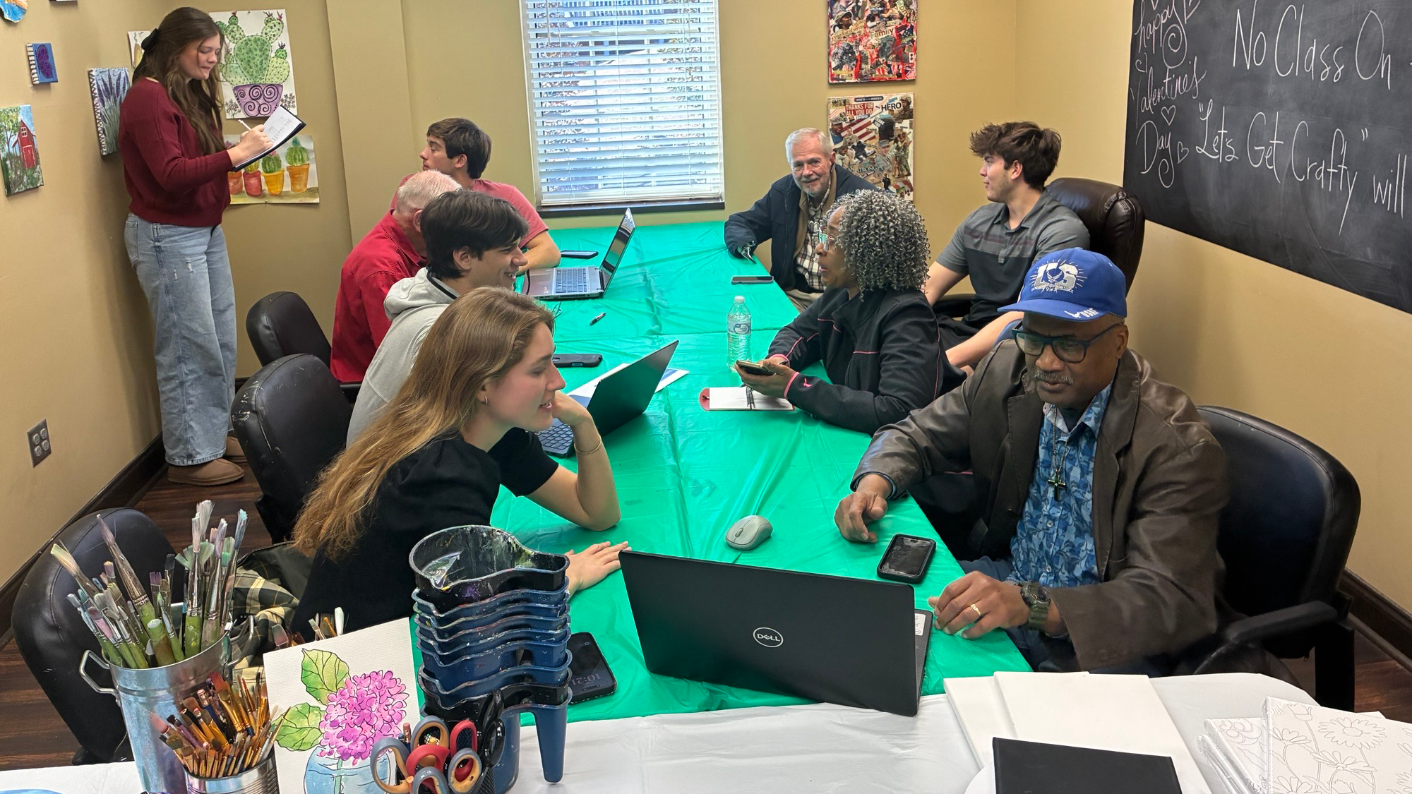 Students and veterans at a table with laptops