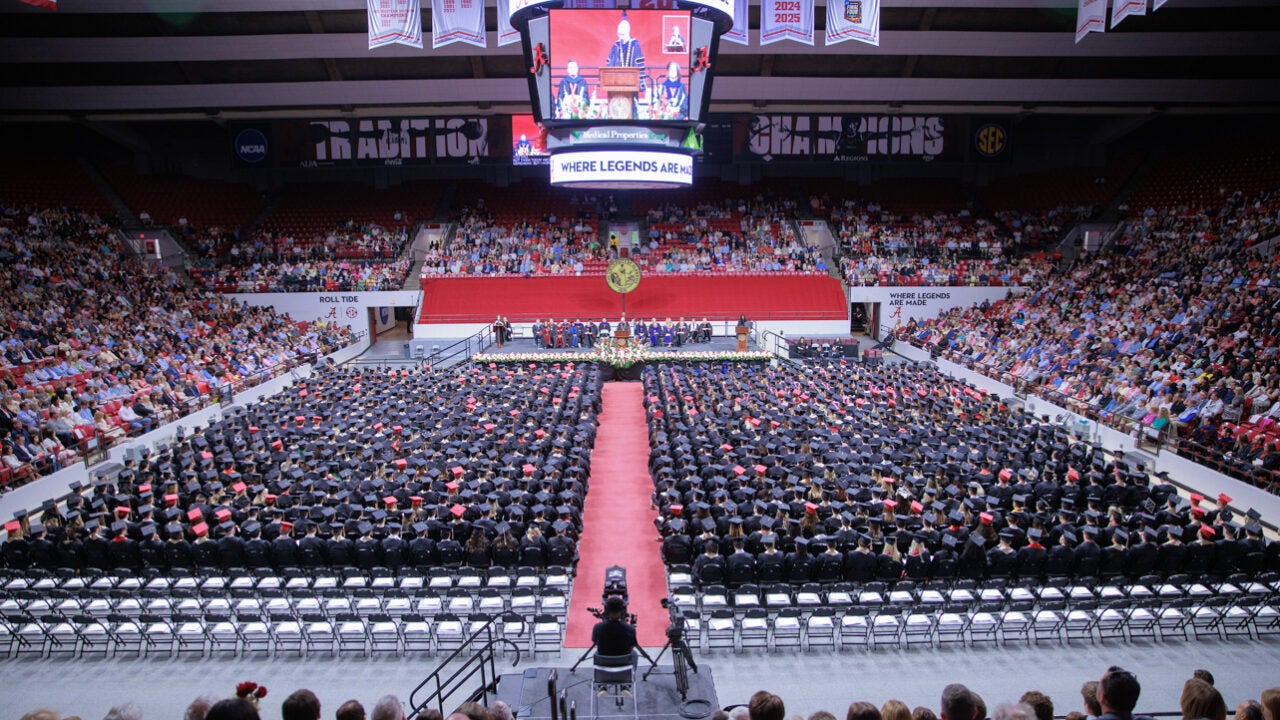 a bird's eye view of the commencement stage showing shows of sears filled with graduates