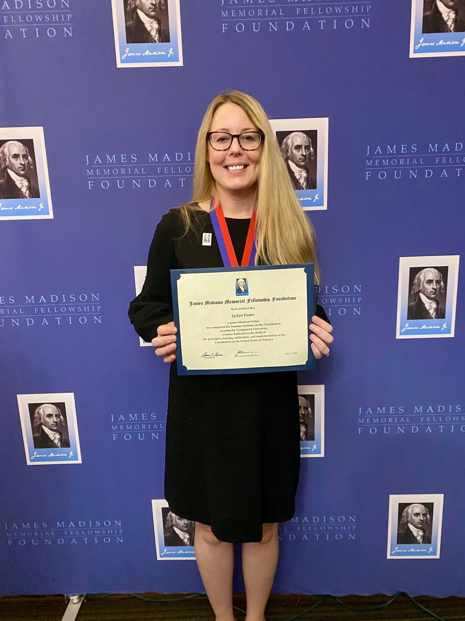 Jaclyn Foster holds up a certificate she received form the james Madison Foundation Fellowship