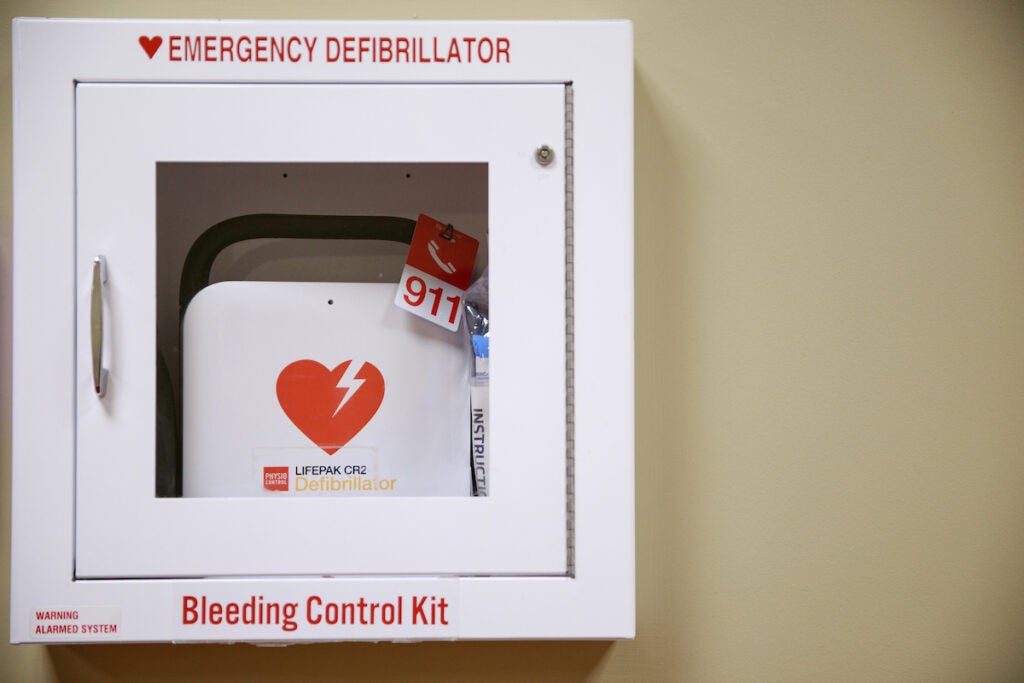 An AED in a cabinet on a wall in a university building.