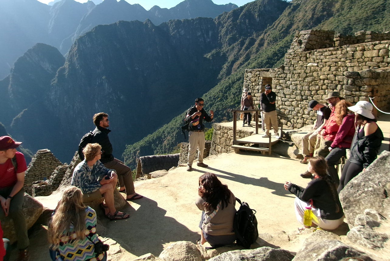 A group of students attend class in Machu Picchu.