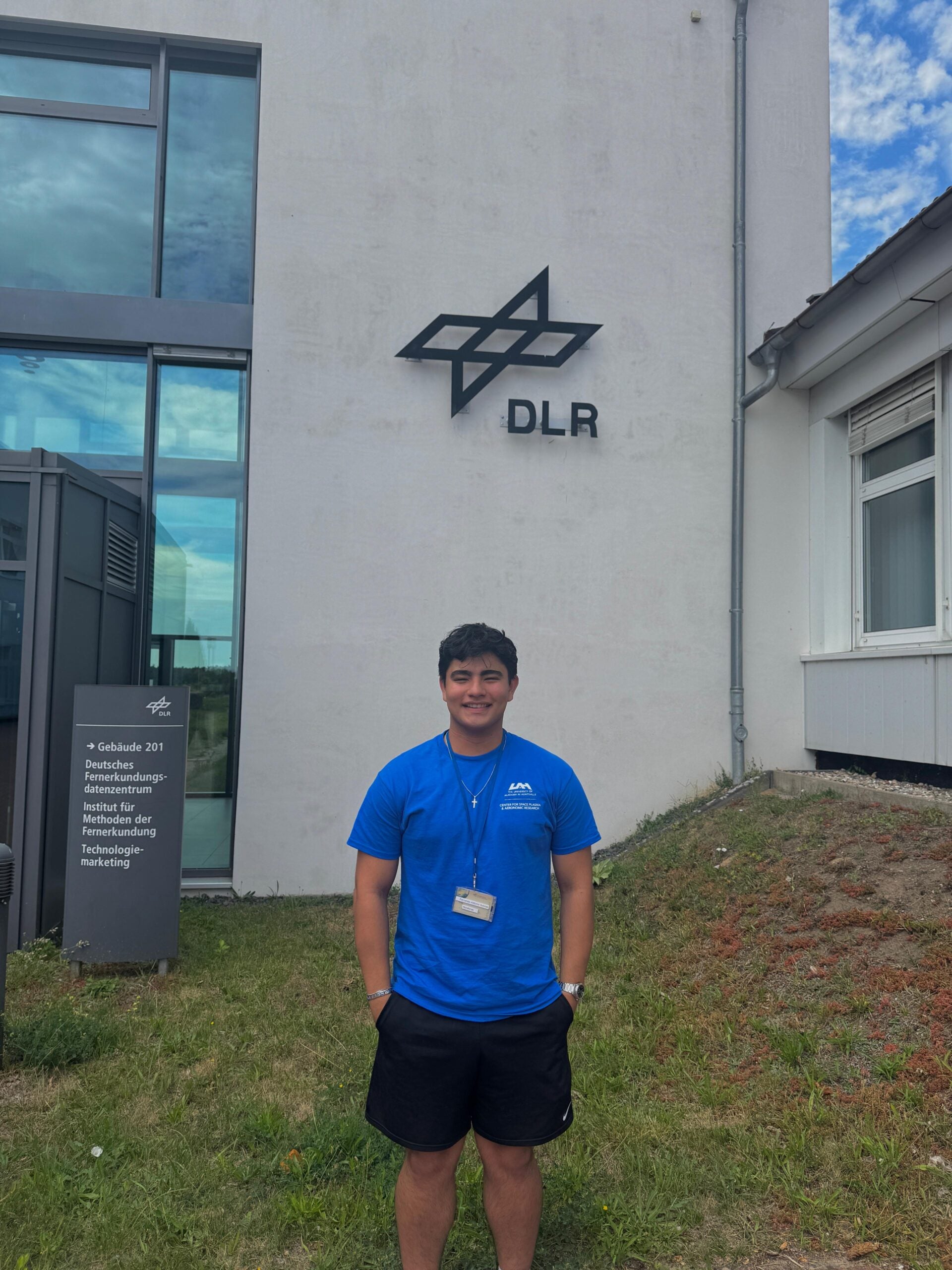 Fernando Salinas, a University of Alabama aerospace engineering student, stands outside a building at the German Aerospace Center (DLR) in Neustrelitz, Germany, during the International Space Weather Camp.