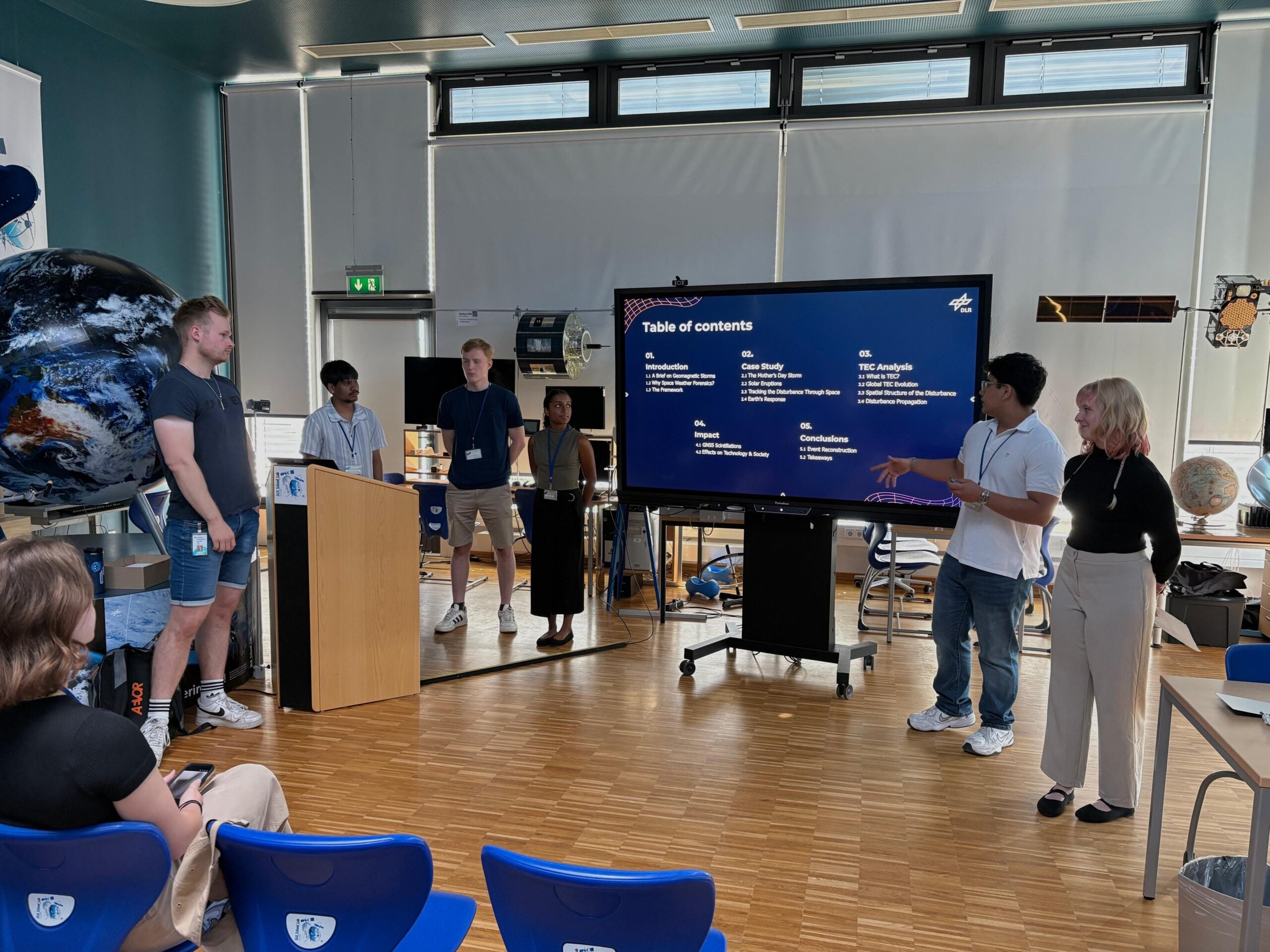 Fernando Salinas presents space weather research findings with fellow International Space Weather Camp participants during a group presentation at the German Aerospace Center.