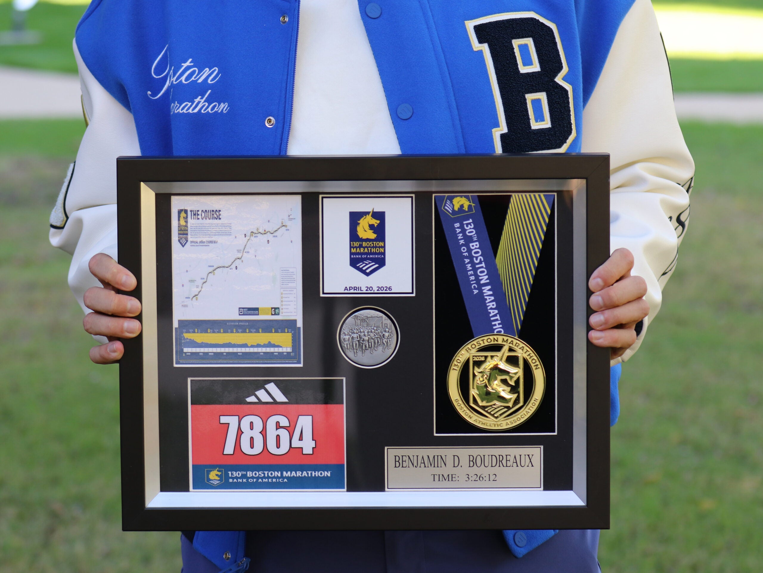 Framed mementoes from the 2026 Boston Marathon including Boudreaux's number, race time and medal. 